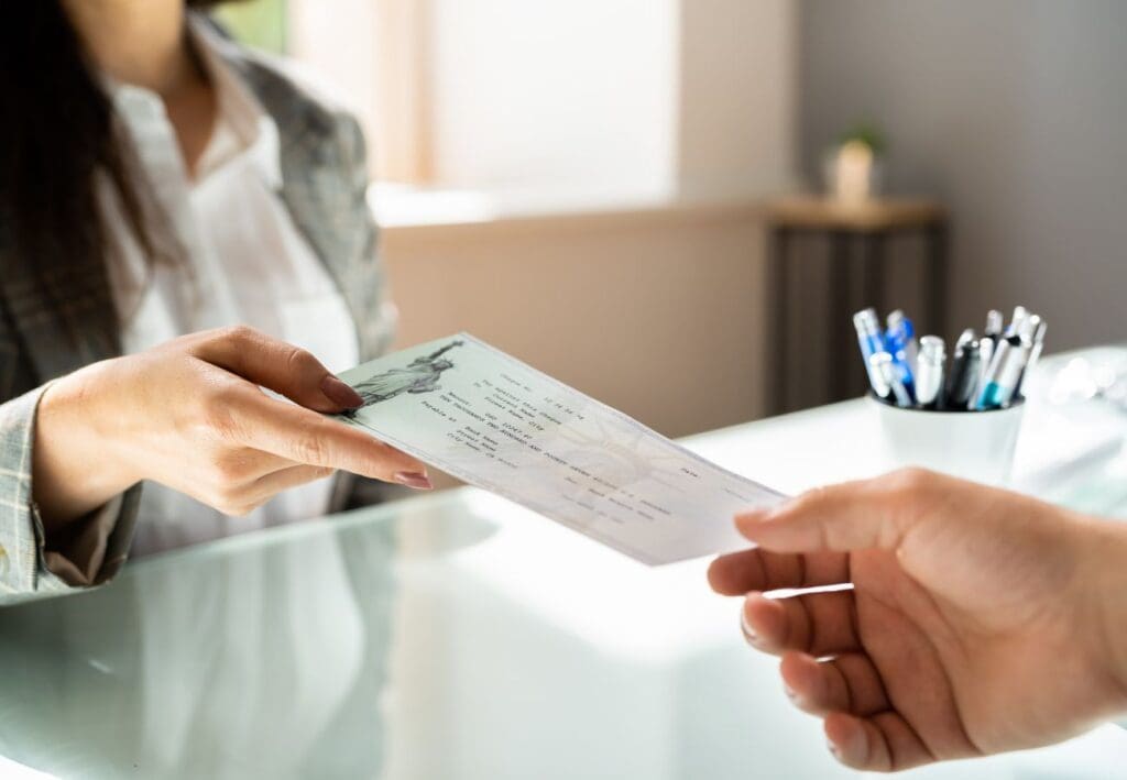 Woman handing a man a check